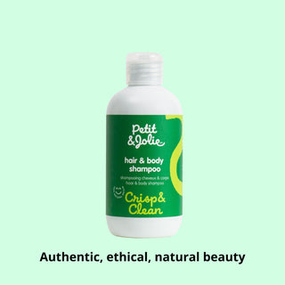 Bottle of Petit & Jolie hair and body shampoo on a light green background