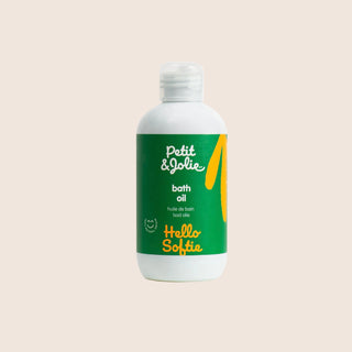 Bottle of Petit & Jolie bath oil on a beige background