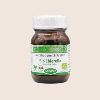 Bottle of Bio Chlorella with a white cap on a beige background