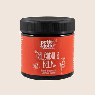 Jar of calendula balm with 'petit & jolie' branding on a beige background