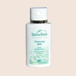 SpiruSkin Cleansing Milk bottle on a beige background