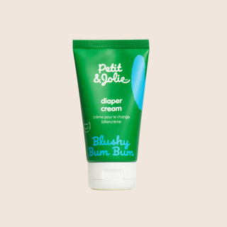 Green tube of Petit Jolie diaper cream on a beige background