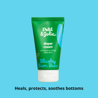 Green tube of Petit é Jolie diaper cream on a blue background