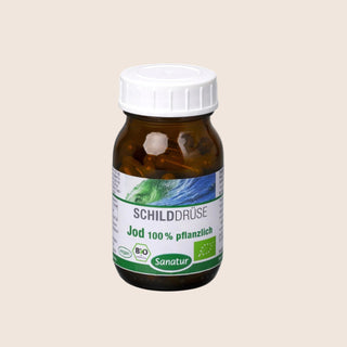 Brown supplement bottle with a white cap on a beige background