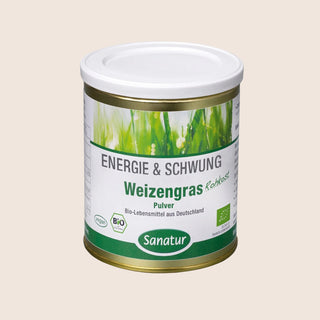 Canister of Sanatur Weizengras (rye grass) powder on a beige background