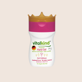 Vitalkind hand gel with a gold cap on a beige background