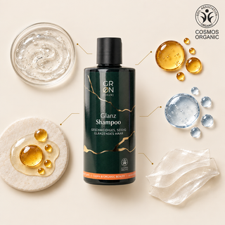 GRN Gloss Shampoo 300 ml surrounded by gel textures, glass droplets and a COSMOS Organic mark