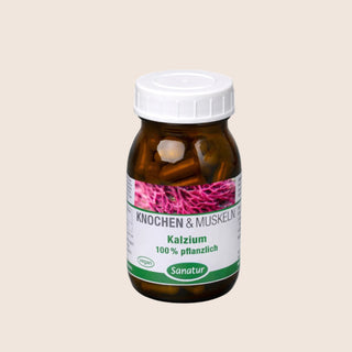 Brown supplement bottle with a white cap on a beige background