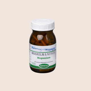 Brown supplement bottle with a white cap on a beige background