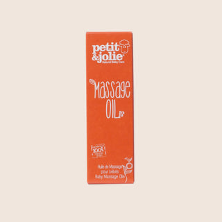 Orange box of petit & jolie massage oil on a beige background